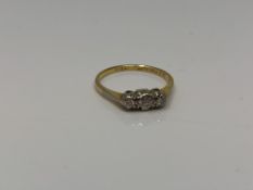 An 18ct gold three stone diamond ring, size O CONDITION REPORT: 2.