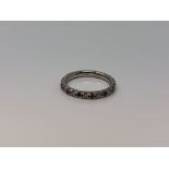 A platinum ruby and diamond half eternity ring,