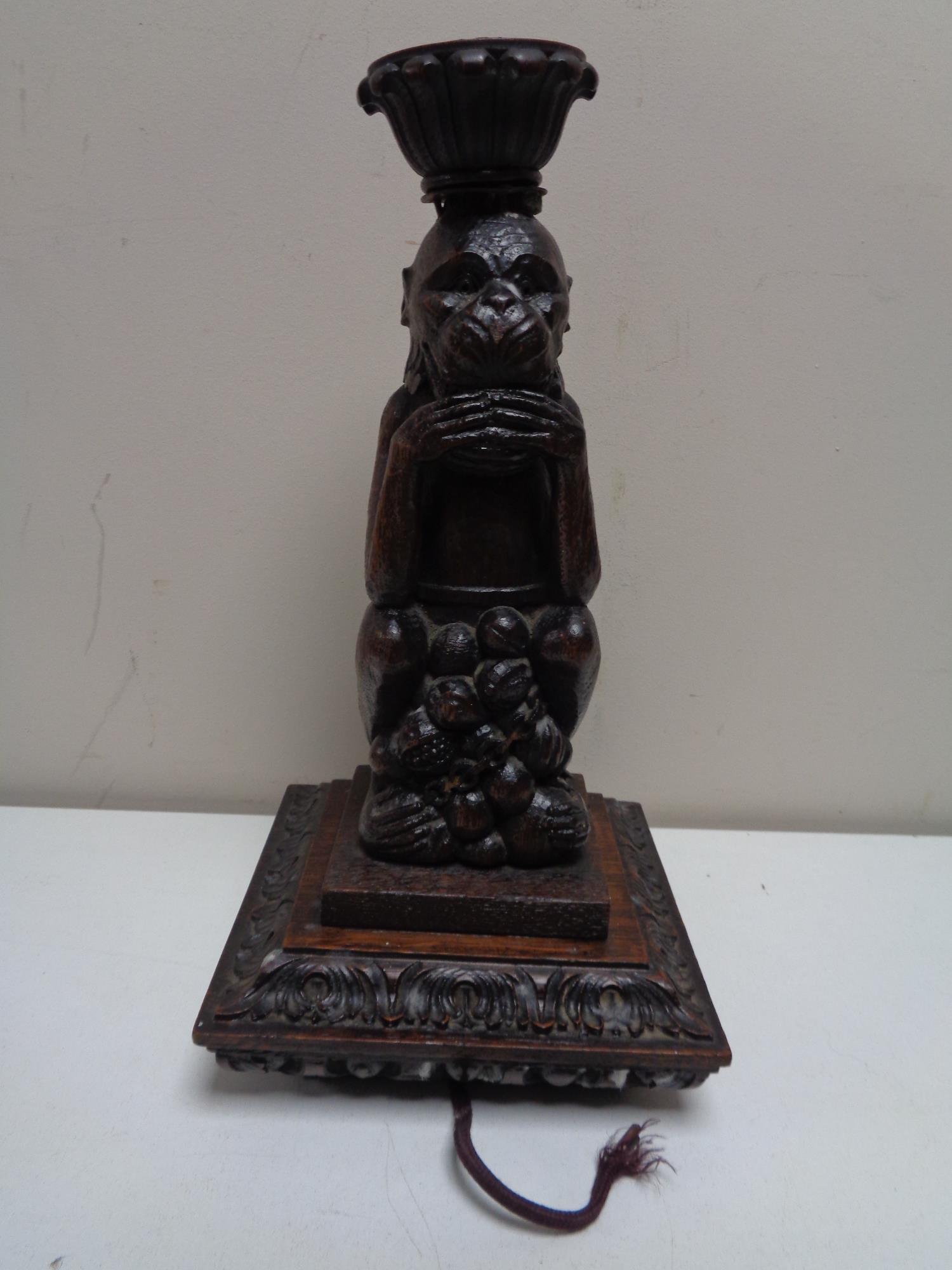 An early twentieth century carved oak figure of a Monkey converted to a lamp