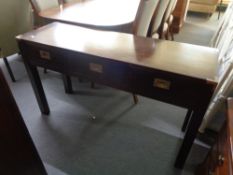 A contemporary military style side table with three drawers and brass corners