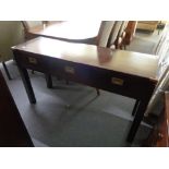 A contemporary military style side table with three drawers and brass corners