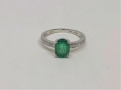 A 14ct white gold emerald and diamond ring, the emerald weighing 0.99 carat, the diamonds 0.