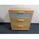 An Ikea light oak three drawer chest