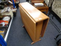 A mid century veneered drop leaf table