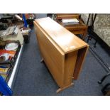 A mid century veneered drop leaf table