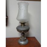 A Victorian metal oil lamp with glass shade