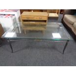 A contemporary metal framed glass topped coffee table