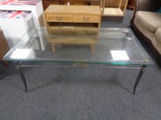 A contemporary metal framed glass topped coffee table