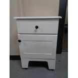 A white wooden bedside cabinet