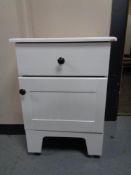 A white wooden bedside cabinet