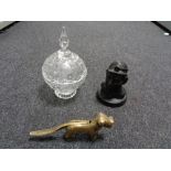 A vintage brass nut cracker in the form of a dog together with a polished coal figure of a miner
