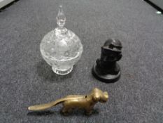 A vintage brass nut cracker in the form of a dog together with a polished coal figure of a miner