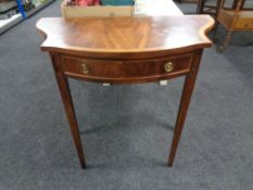 A reproduction mahogany shaped side table fitted with a drawer