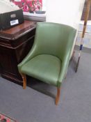 A studded side chair in green covering