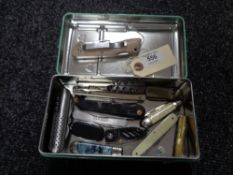 A tin of pen and pocket knives