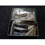 A tin of pen and pocket knives