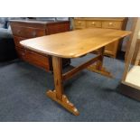 An Ercol style polished elm dining table