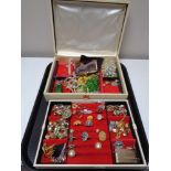A mid century jewellery box with lift out tray containing rings, brooches, beaded necklaces,
