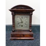 An Edwardian stained beech mantel clock