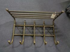 A metal coat rack together with wooden stair rod fittings, antique wooden box containing clips,