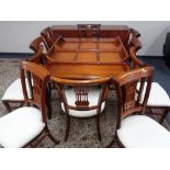 A good quality Chinese hardwood extending dining table together with ten chairs,