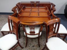 A good quality Chinese hardwood extending dining table together with ten chairs,