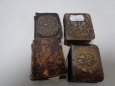 A bag of three antique silver fronted miniature prayer books and one other