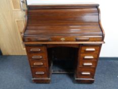 A nineteenth century mahogany roll topped desk