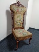 A Victorian walnut framed tapestry upholstered prayer chair