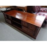 A reproduction mahogany low storage coffee table fitted with drawers