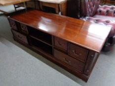 A reproduction mahogany low storage coffee table fitted with drawers