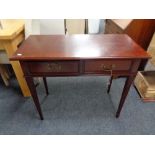 A reproduction mahogany two drawer side table