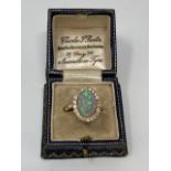 An 18ct gold opal and diamond cluster ring, size R.