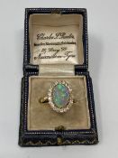 An 18ct gold opal and diamond cluster ring, size R.