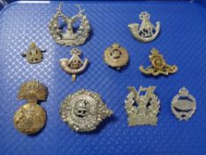 A quantity of military cap badges etc