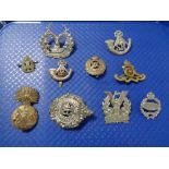 A quantity of military cap badges etc