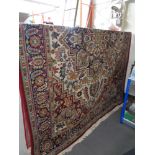 A large machine made fringed Eastern carpet CONDITION REPORT: 250 cm x 340 cm
