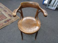 An antique bentwood armchair