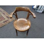 An antique bentwood armchair