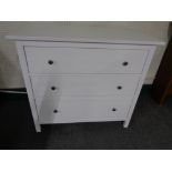 A contemporary white three drawer chest together with a matching two drawer chest