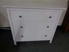 A contemporary white three drawer chest together with a matching two drawer chest