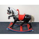 A good quality composition rocking horse on wooden base, designed by George Heeler,
