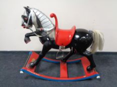 A good quality composition rocking horse on wooden base, designed by George Heeler,