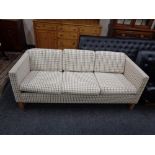 A Continental three seater settee upholstered in light tartan fabric