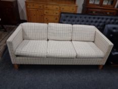 A Continental three seater settee upholstered in light tartan fabric