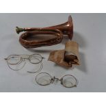 A miniature copper and brass bugle, antique spectacles,
