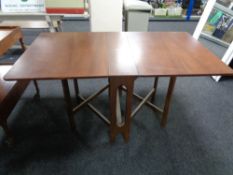 A mid century teak drop leaf table