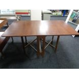 A mid century teak drop leaf table