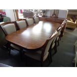A Willis and Gambier extending dining room table on double pedestal with leaf,
