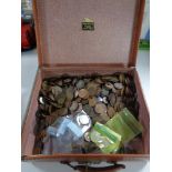 A vintage suitcase containing a large collection of coins,
